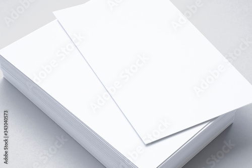 Close view of blank business cards isolated on grey. illustration of vertical stacks to showcase your presentation.