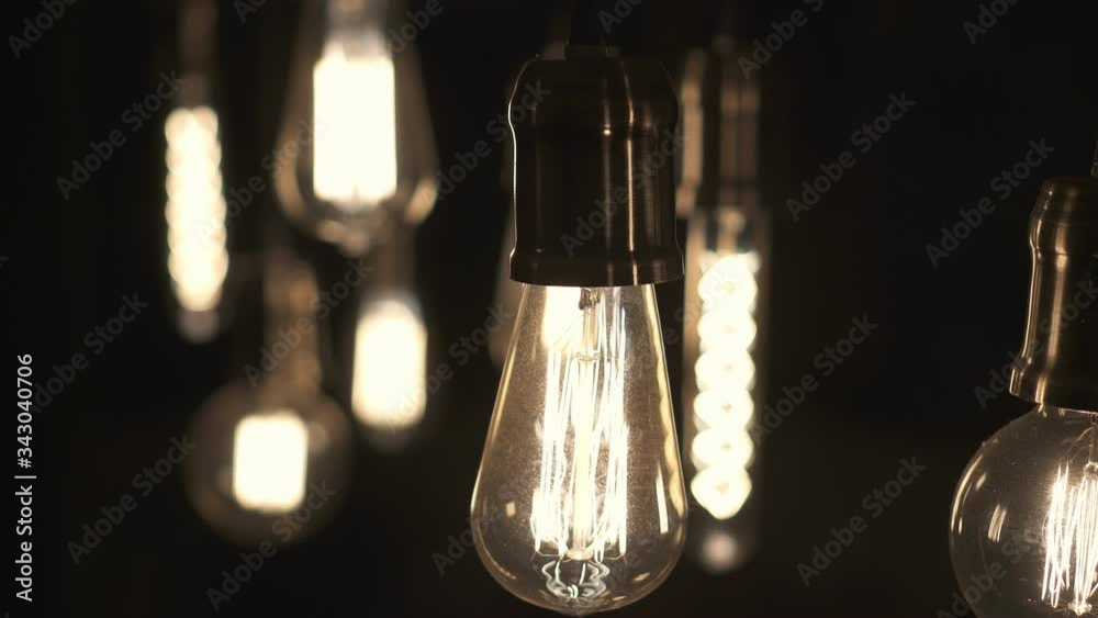 Turning light ON and OFF. Decorative antique edison style light bulbs hanging from the ceiling.