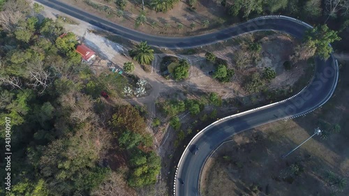 Aerial Footage of Snake Shaped Road Surrounded by Trees in Nakhon Panom, Thailand photo