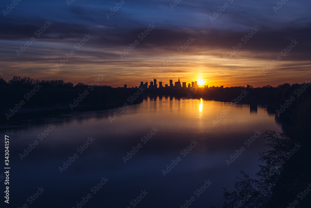 Sunset over city downtown seen from Siekierkowski Bridge in Warsaw, capital of Poland