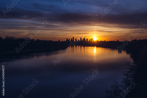 Sunset over city downtown seen from Siekierkowski Bridge in Warsaw, capital of Poland