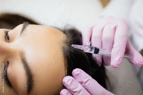 hair treatment in cosmetology using mesotherapy. injection to the head. selective focus