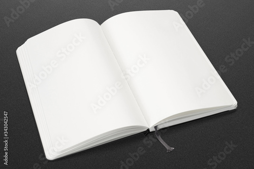 Opened sketchbook with blank and white pages on dark background. illustration to showcase your artwork presentation.