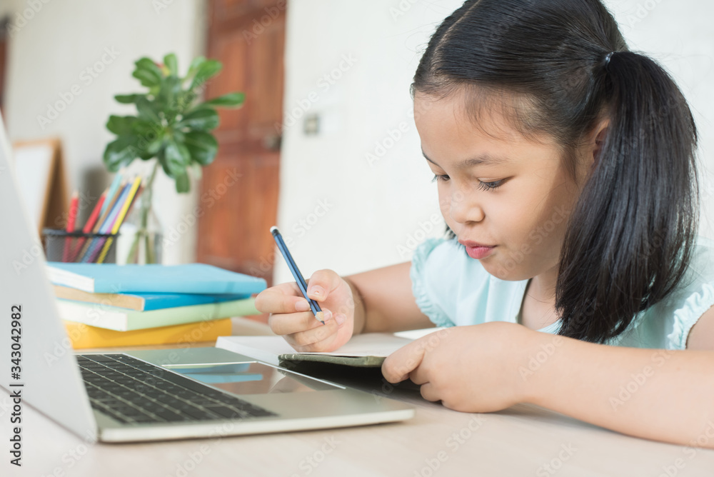 pretty stylish schoolgirl studying homework during online lesson at home, social distance during quarantine, self-isolation, online education concept, home school, study online video call teacher. pretty stylish schoolgirl studying homework during online lesson at home, social distance during quarantine, self-isolation, online education concept, home school, study online video call teacher.