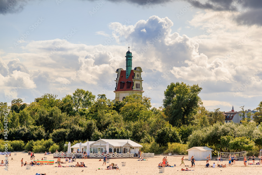 SOPOT, POLEN - 2017 AUGUST 25. The publick beach and view of Evangelical church, Kostel Spasitele in Sopot.