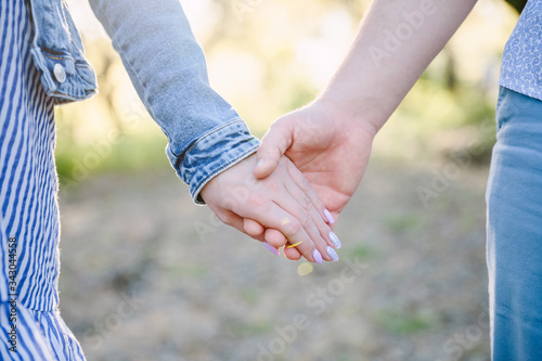 Couple Wife Husband Dating Relaxation Love Concept. Couple hands together touch with love. People, family, care and support concept - close up of young woman and man holding hands together