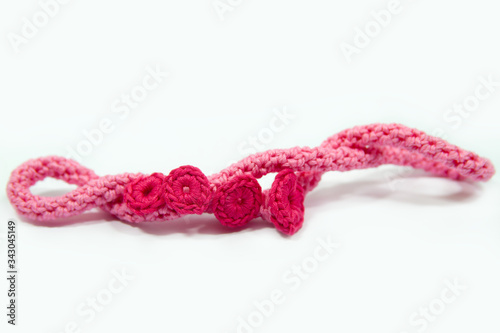 Pink cotton crocheted necklace isolated on white
