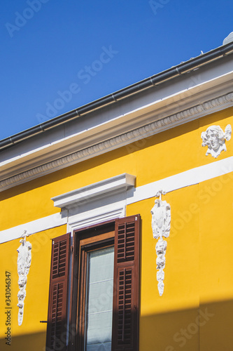 yellow colored building with white ornaments on the facade in Pula, Istrian Peninsula in Croatia