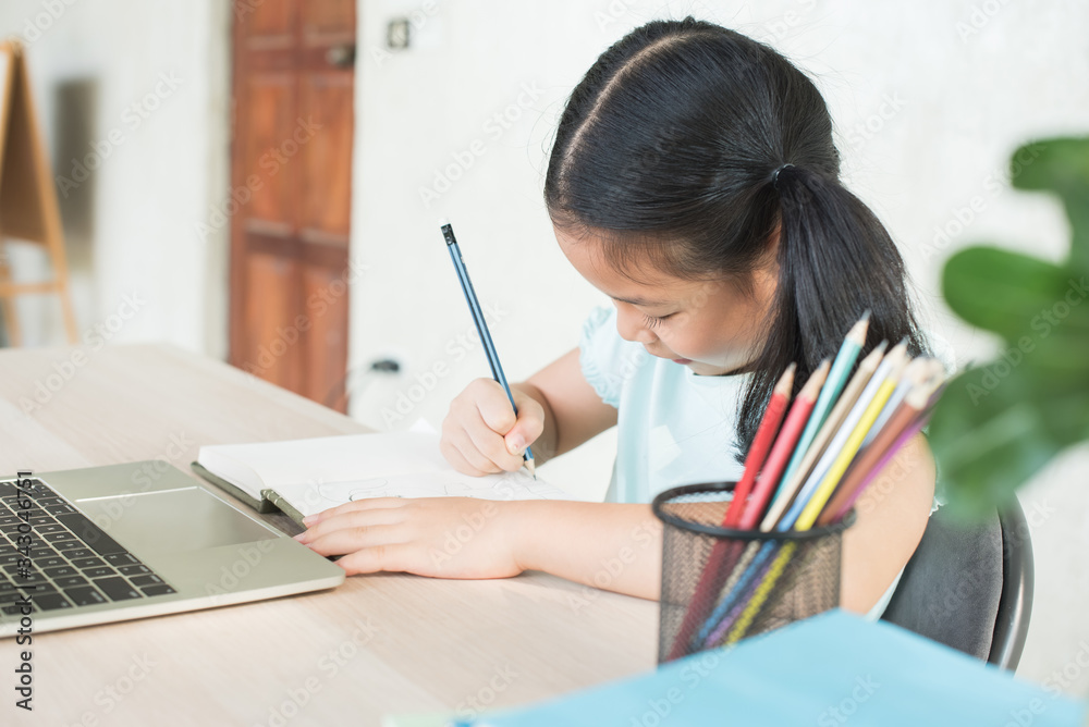 pretty stylish schoolgirl studying homework during online lesson at home, social distance during quarantine, self-isolation, online education concept, home school, study online video call teacher. pretty stylish schoolgirl studying homework during online lesson at home, social distance during quarantine, self-isolation, online education concept, home school, study online video call teacher.