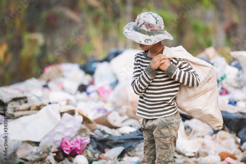 Poor children collect garbage for sale because of poverty, Junk recycle, Child labor, Poverty concept, human trafficking, World Environment Day,