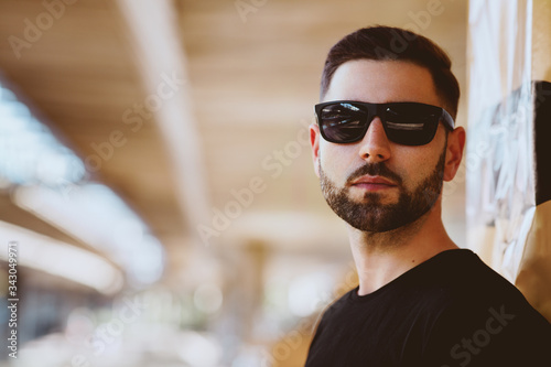 Portrait of a short bearded man wearing black sunglasses © djile