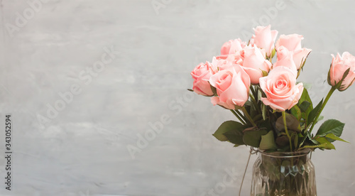 Vertical view of delicate roses on vase