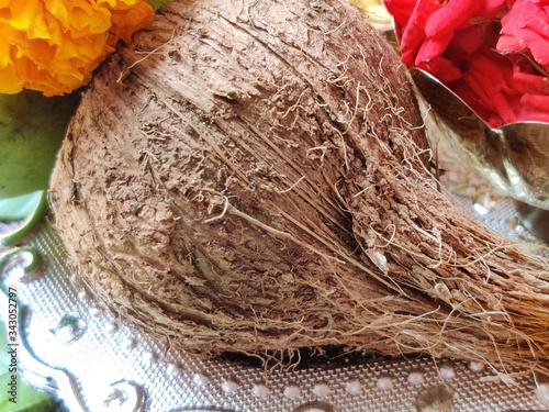 Copper Kalash with coconut and mango leaf with floral decoration on a white background. photo