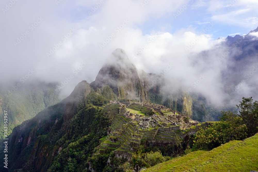 Machu Picchu city and mountains covered with clouds