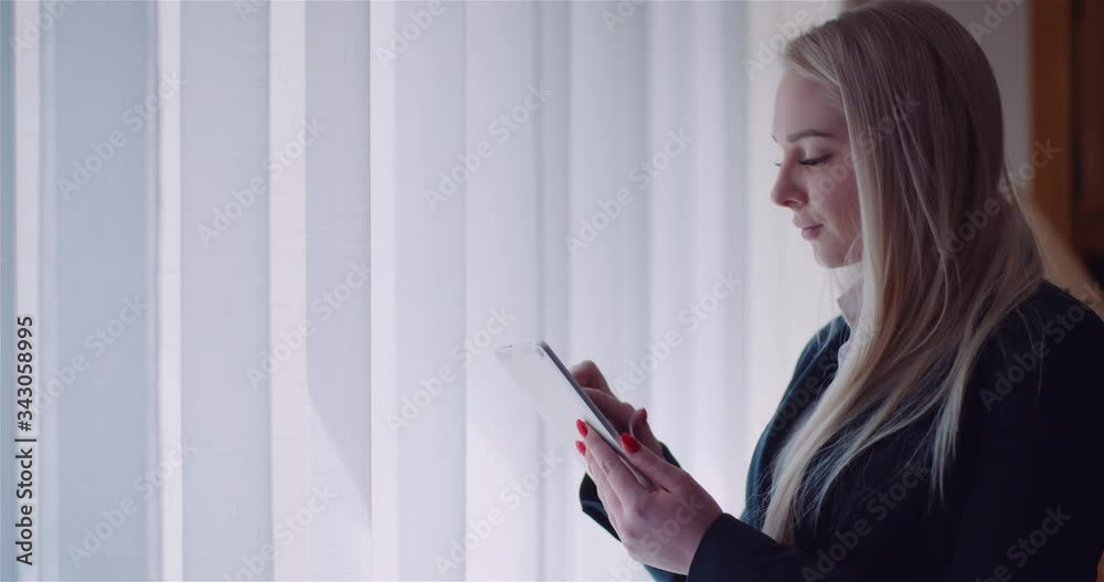 Businesswoman Using Digital Tablet at Home Office Browsing internet Reading emails. Businesswoman Using Digital Tablet at Home Office Browsing internet Reading emails.