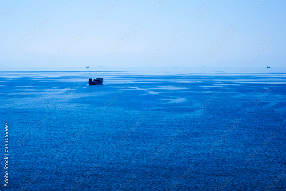 A large transport ship sailing far horizon A large transport ship sailing far horizon