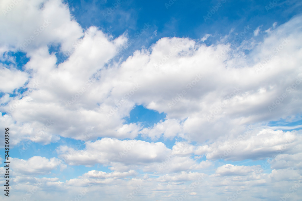 Horizontal view of a light, blue sky with white clouds. Airy, vibrant atmosphere Horizontal view of a light, blue sky with white clouds. Airy, vibrant atmosphere
