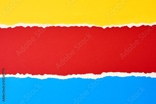 Torn ripped paper edge with a copy space, red, blue and yellow color background