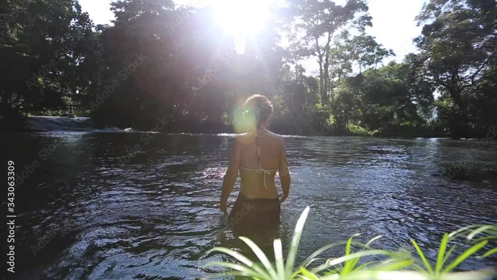 A young woman enjoying the Pulhapanzak waterfall on Lake Yojoa. Honduras