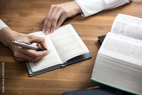 Business young woman sitting working and thinking with calendar and book.