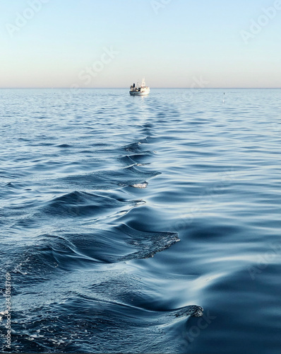 Fototapeta Naklejka Na Ścianę i Meble -  Fishing boat at the end of the waves