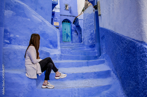 Woman in the old blue city of Chefchaouen, Morocco. © Celeste