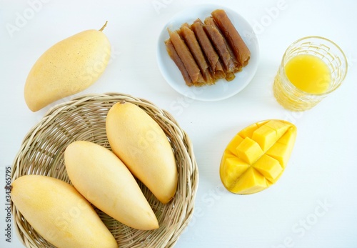 mango juice and mango sheets. Healthy fruit on a white background