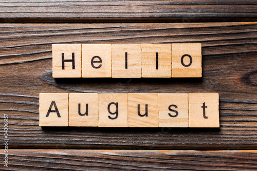 hello august word written on wood block. hello august text on table, concept photo