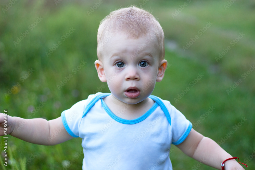 Handsome, blonde, open month kid in blue t-shirt. Handsome, blonde, open month kid in blue t-shirt.