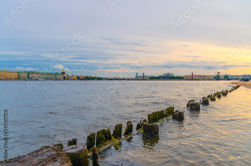 Wooden fence in Neva river water on Zayachy Hare Island  cityscape of Saint Petersburg Leningrad  Winter Palace  State Hermitage Museum  Saint Isaac s Cathedral  Arrow of Vasilyevsky Island  Russia