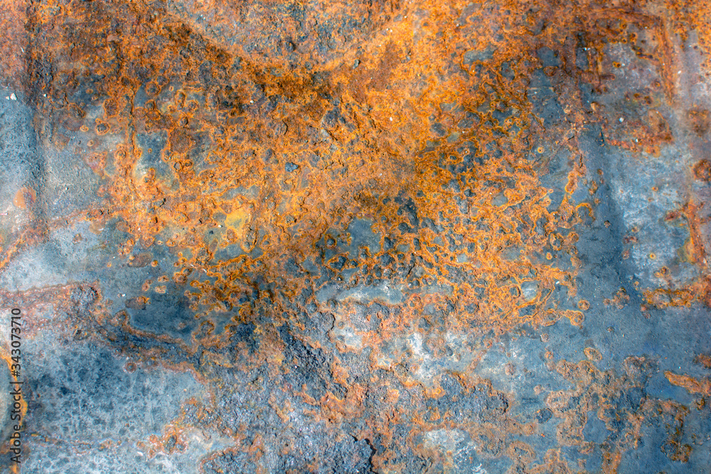The iron, metal surface was covered with strange patterns of rust, from the effects of the environment. Close-up photo