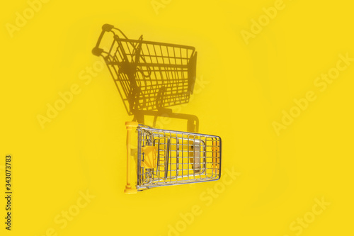 Shopping cart on yellow background.