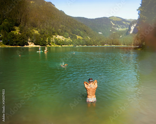 Leisure time on the lake of Montriond, natural lake in Portes du Soleil, Haute -Savoie region, France, an attraction for many tourists, with swimming area, fishing, canoeing. © elephotos