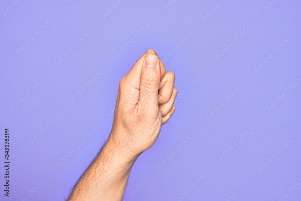 Hand of caucasian young man showing fingers over isolated purple background holding blank space with thumb finger, business and advertising Hand of caucasian young man showing fingers over isolated purple background holding blank space with thumb finger, business and advertising