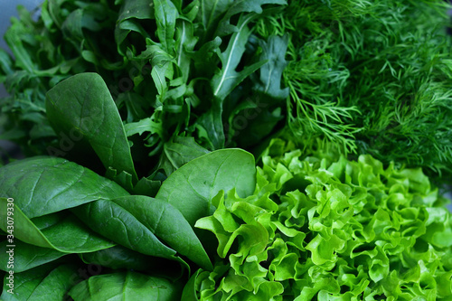 Fresh Organic Raw Greens. Creative layout of green leaves. green crispy Lettuce salad, Spinach, dill, arugula. vegan, vegetarian concept.Spring avitaminosis