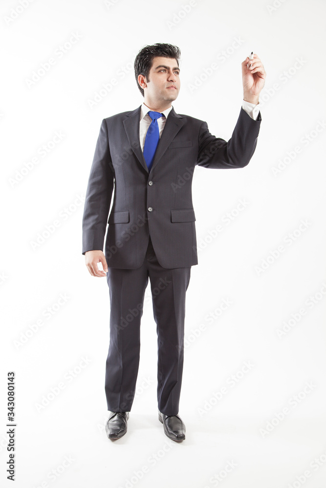 Business man wearing suit pretends to write on screen camera holding marker front view