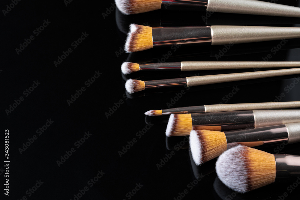 Collection of make up brushes on black background, close up Collection of make up brushes on black background, close up