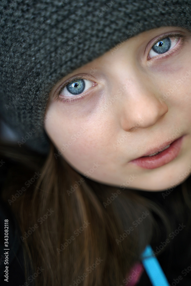 portrait of a serious beautiful girl with blue eyes