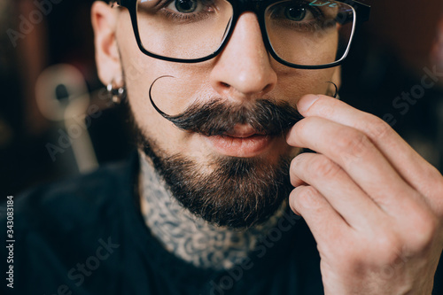 Well groomed hipster. Barbershop concept. Beauty industry. Facial hair care. Mature man bearded hipster with long beard and mustache. Styling mustache. Growing long mustache. Moustache style
