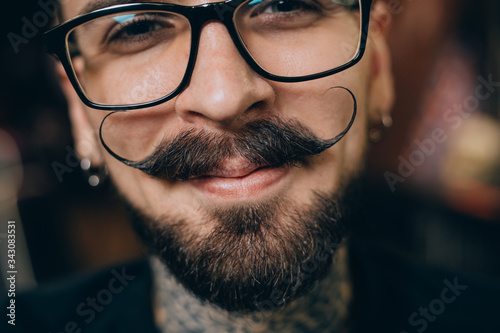 Well groomed hipster. Barbershop concept. Beauty industry. Facial hair care. Mature man bearded hipster with long beard and mustache. Styling mustache. Growing long mustache. Moustache style