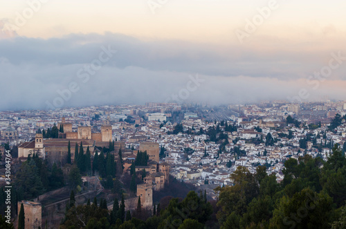 View of the Alhambra and the Generalife and the city of Granada from the viewpoint of the Silla del Moro at sunrise.