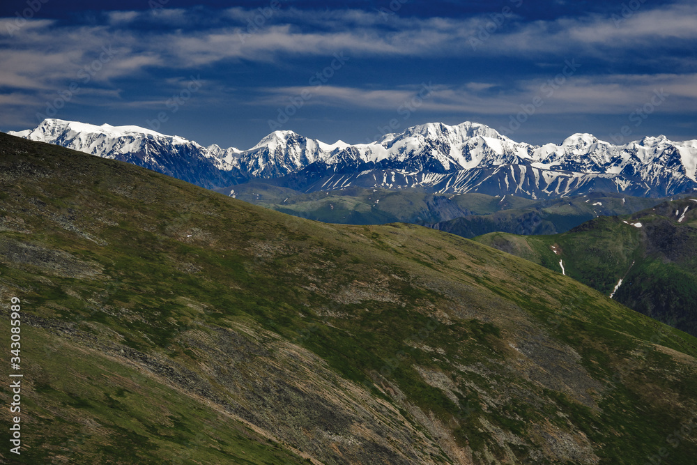 Spectacular view from the top of the mountain to the mountain range in the Ulagansky District of the Altai republic, Russia Spectacular view from the top of the mountain to the mountain range in the Ulagansky District of the Altai republic, Russia