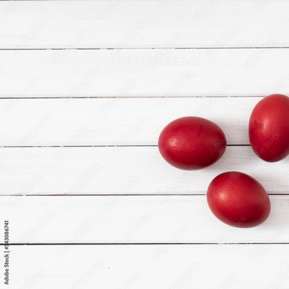 Natural easter concept. Red colored eggs on white wooden background. Flat lay, top view, copy space