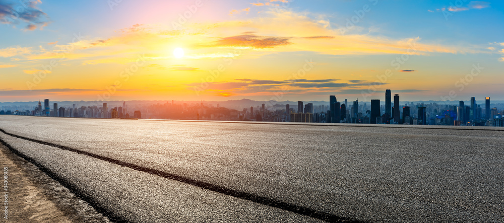 Empty asphalt road and Chongqing city skyline and buildings at sunset,China.