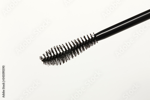 Close-up of a mascara brush with a white background