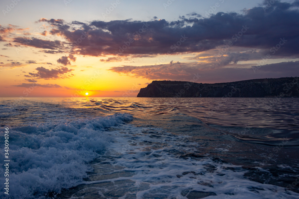 Raging sea waves at sunset in the ocean. Storm clouds on the sea. Raging sea waves at sunset in the ocean. Storm clouds on the sea.