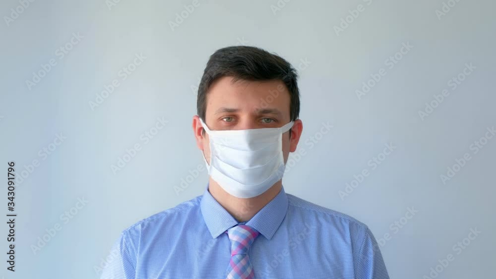 Portrait of man in protective medical mask on face, coronavirus pandemic. Man in shirt with tie, office worker on white background. Worldwide global COVID-19 epidemic. Fighting 2019-ncov infection. Portrait of man in protective medical mask on face, coronavirus pandemic. Man in shirt with tie, office worker on white background. Worldwide global COVID-19 epidemic. Fighting 2019-ncov infection.