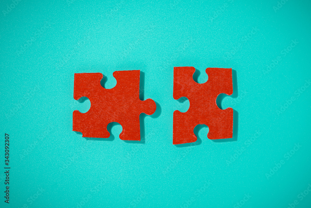 Two red piece flat puzzle jigsaw on blue background Two red piece flat puzzle jigsaw on blue background