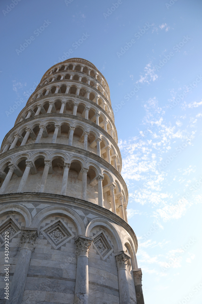 Tower of Pisa stands out against a blue sky