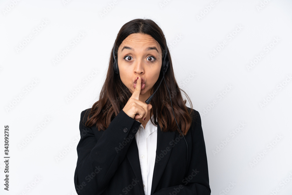 Young telemarketer woman isolated on white background showing a sign of silence gesture putting finger in mouth Young telemarketer woman isolated on white background showing a sign of silence gesture putting finger in mouth